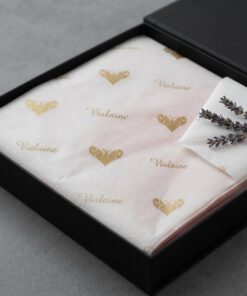 Personalized white tissue paper with gold print for upscale boutique unboxing