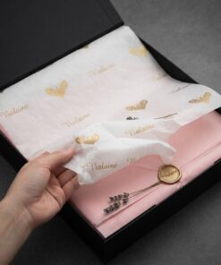 Custom printed white tissue paper with gold foil logo for luxury gift boxes