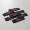 Black damask woven labels with website text