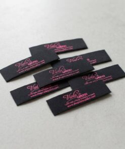 Black damask woven labels with website text