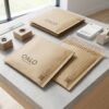 Biodegradable look self-sealing kraft bubble envelopes